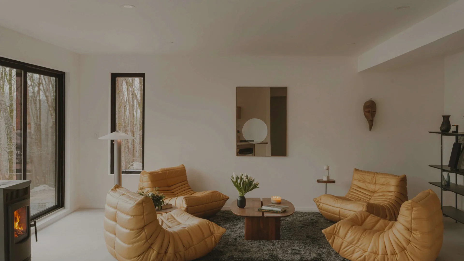 Cozy living room with modern furniture and fireplace.